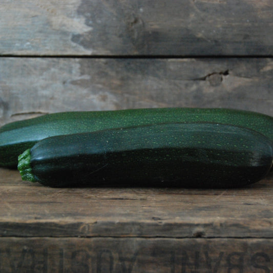 Zucchini on a wooden surface with a rustic background