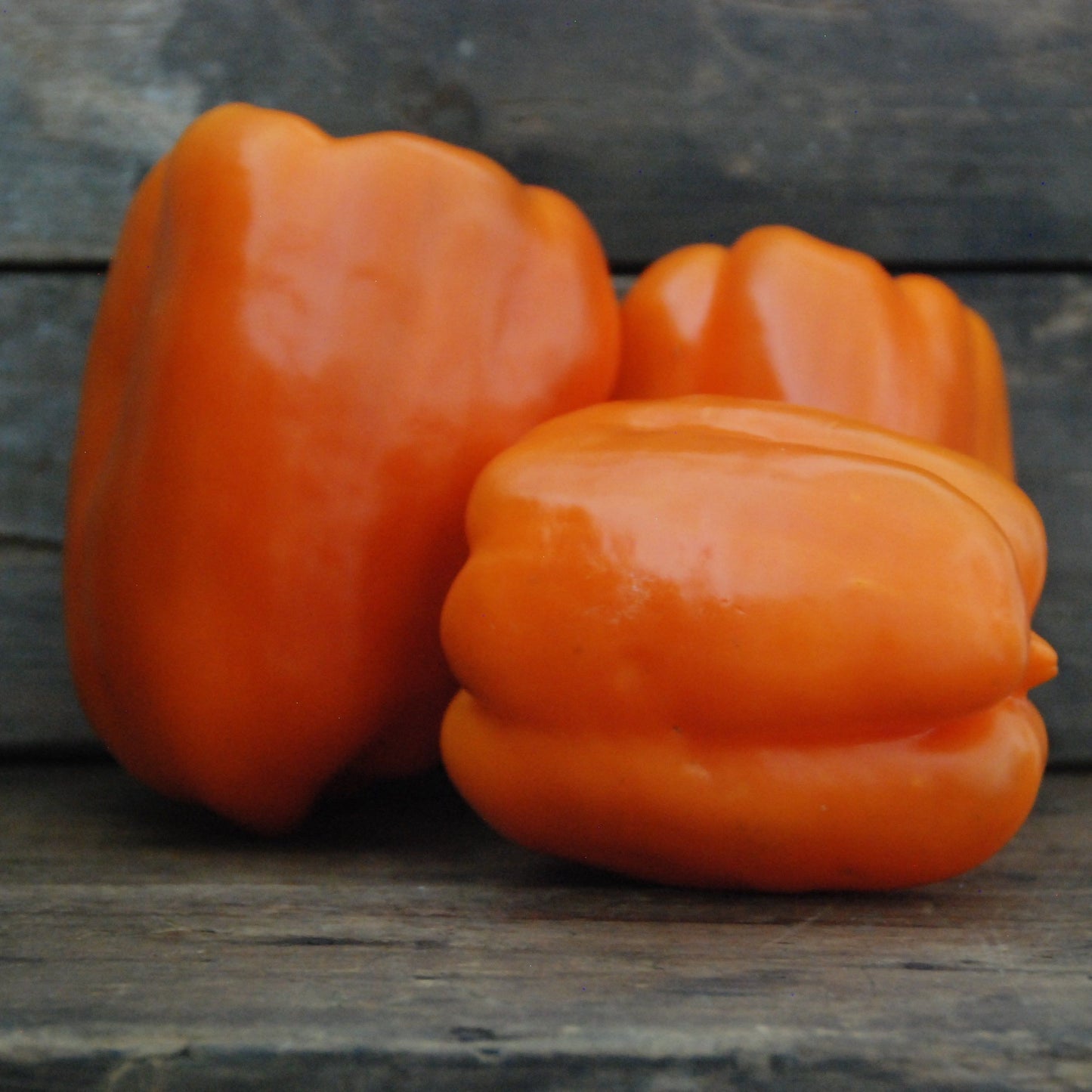 Orange bell pepper on a wooden surface