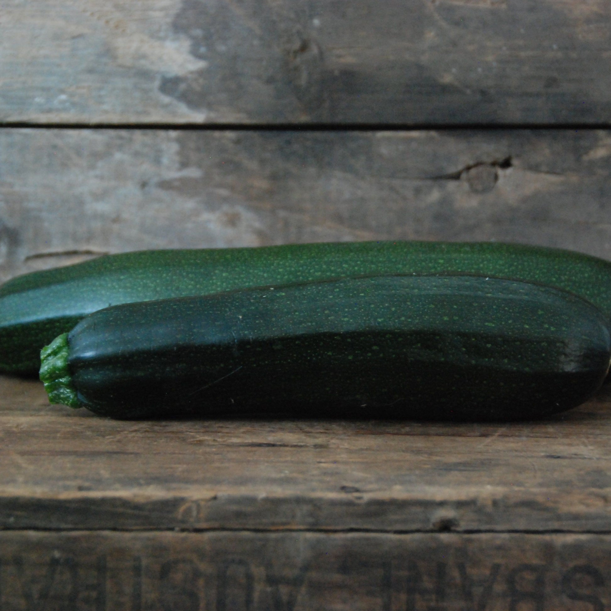 Zucchini on a wooden surface with a rustic background