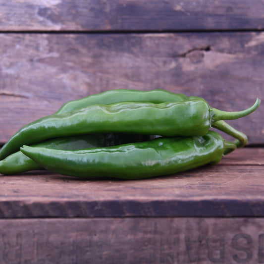 Green peppers on a wooden surface