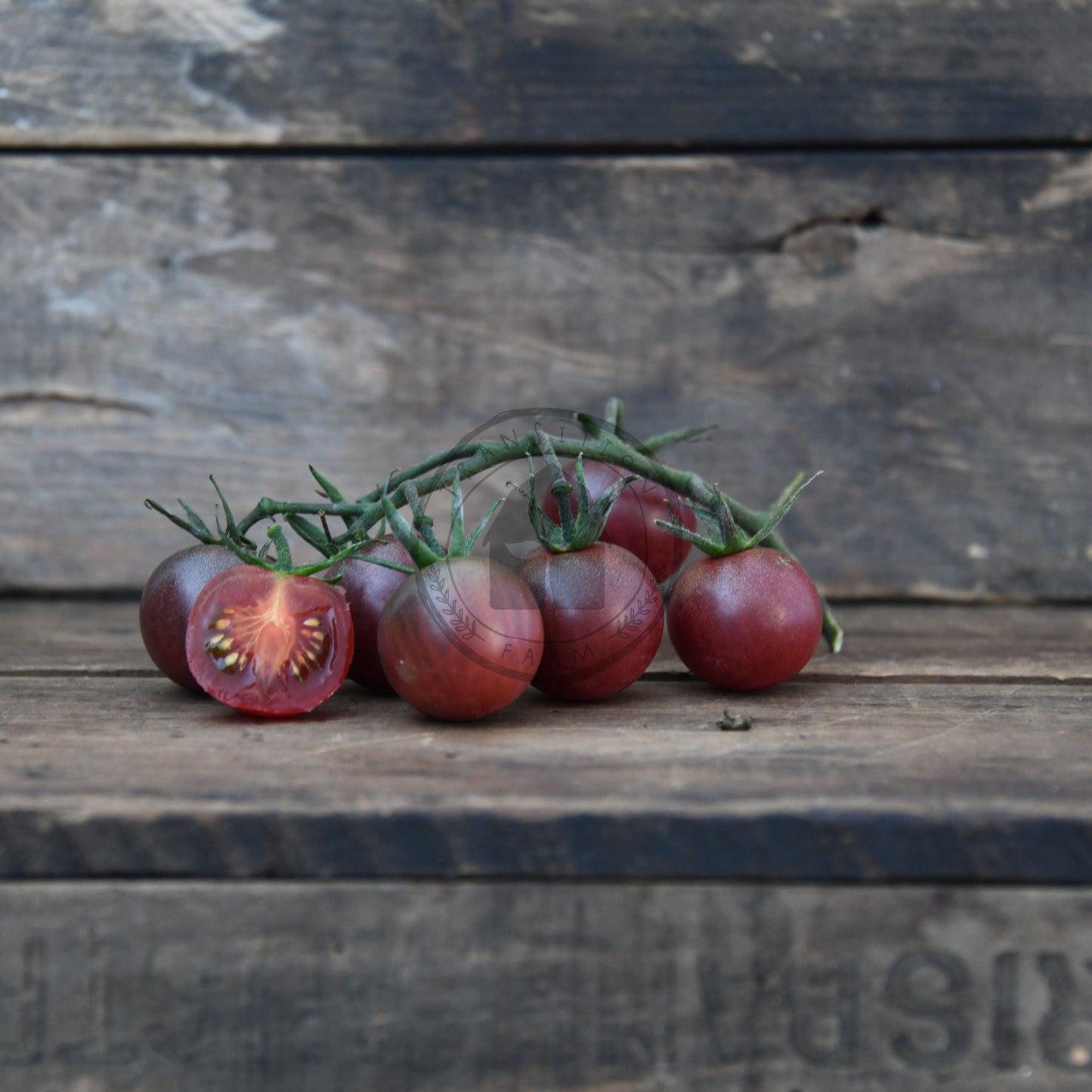 black cherry tomatoes on a wooden surface