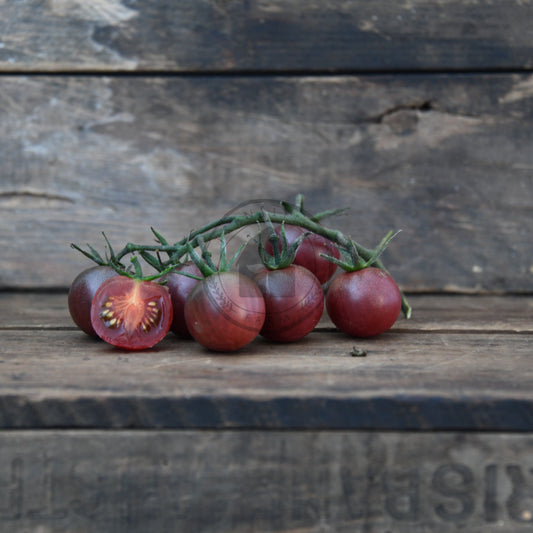 black cherry tomatoes on a wooden surface