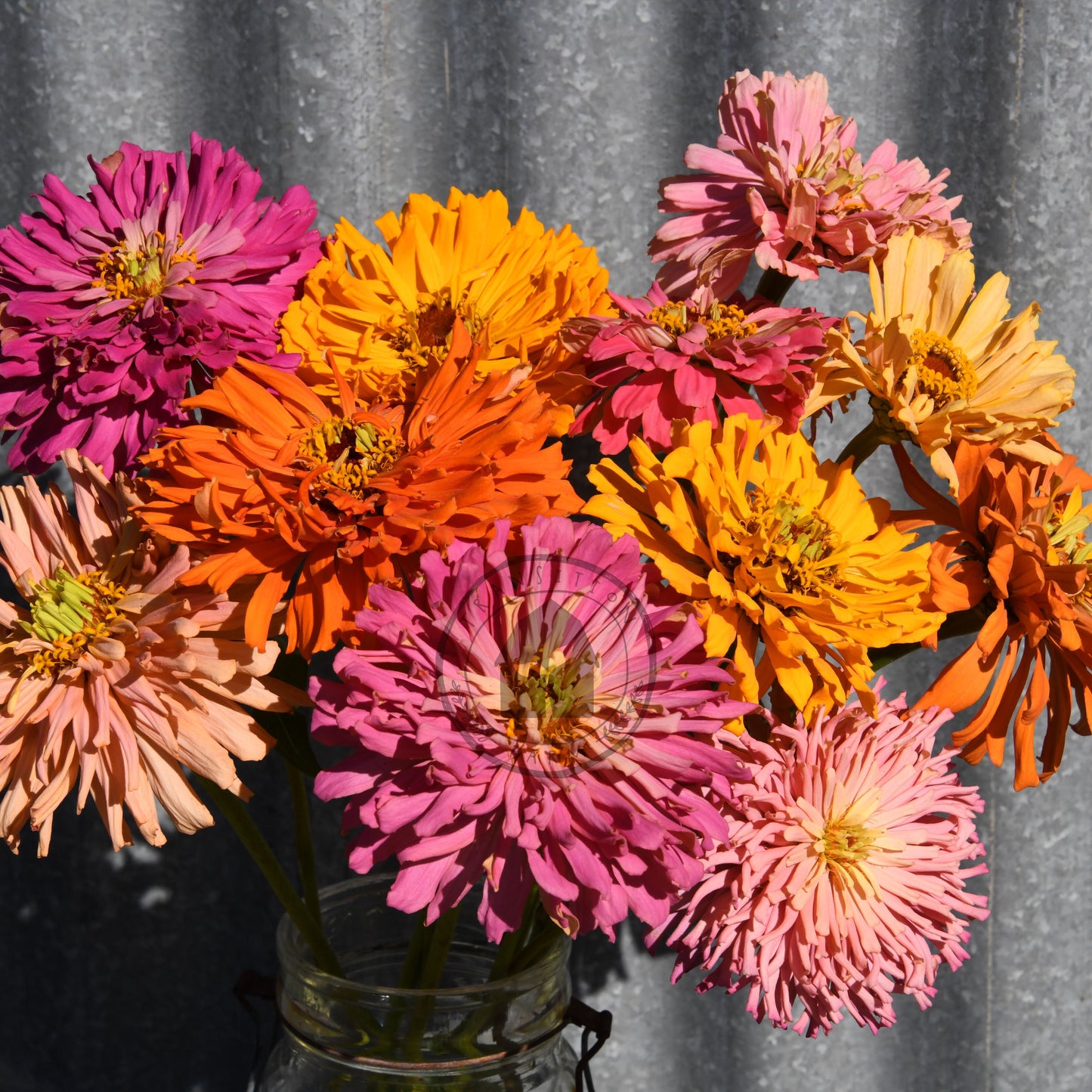 Bouquet of colorful flowers in a vase against a gray curtain background