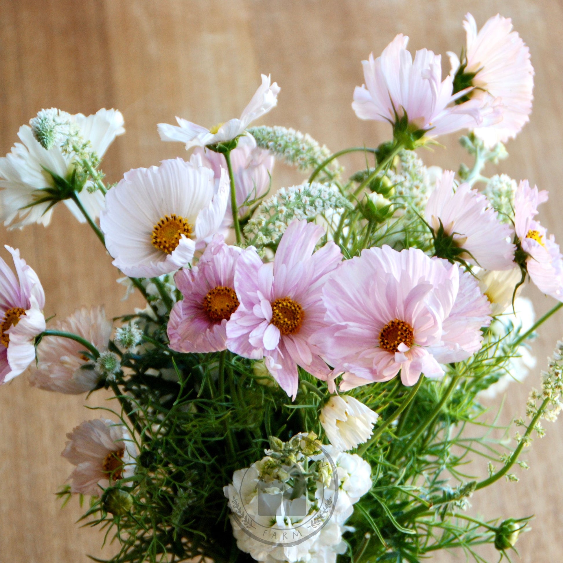 Bouquet of pink and white flowers on a wooden surface