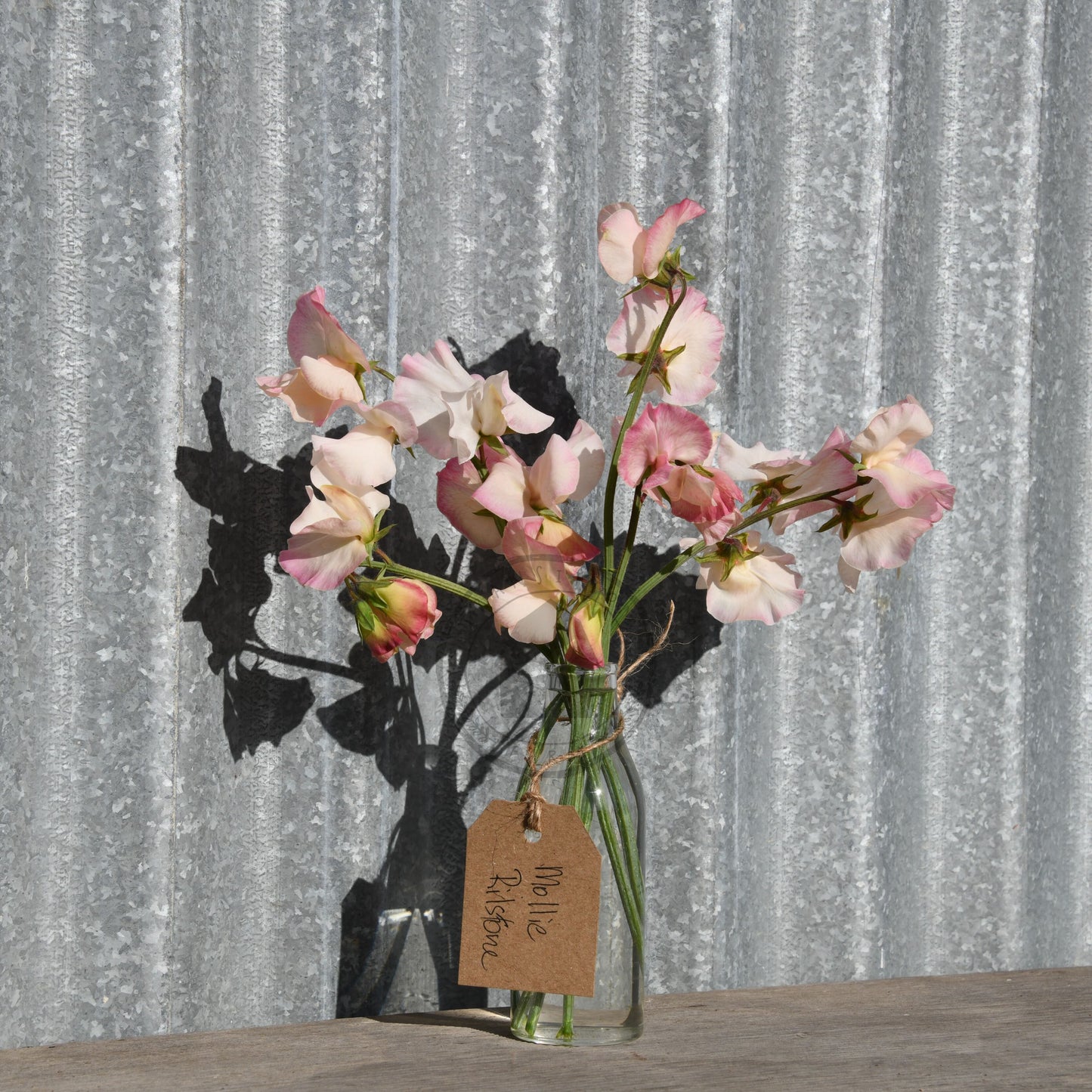 Bouquet of flowers in a glass vase with a decorative background
