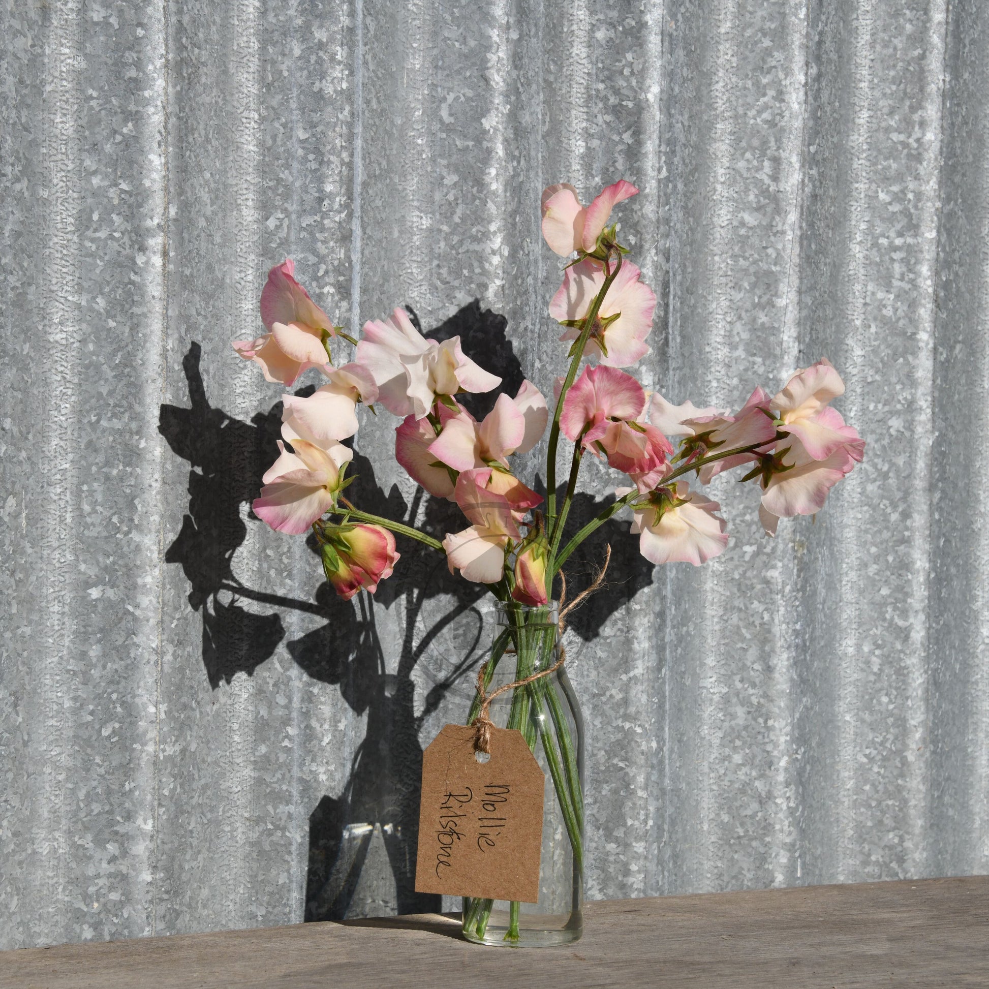 Bouquet of flowers in a glass vase with a decorative background