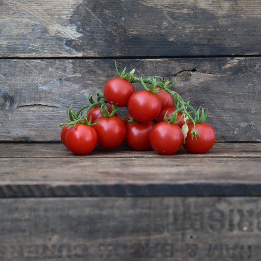 Bunch of red tomatoes on a wooden surface